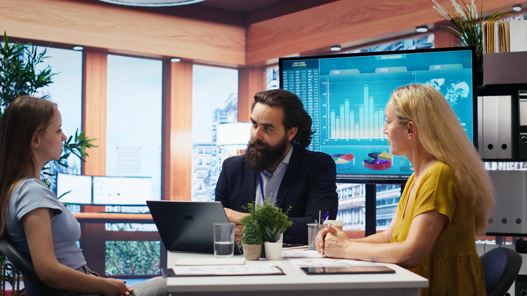 Team reviewing digital investment dashboard