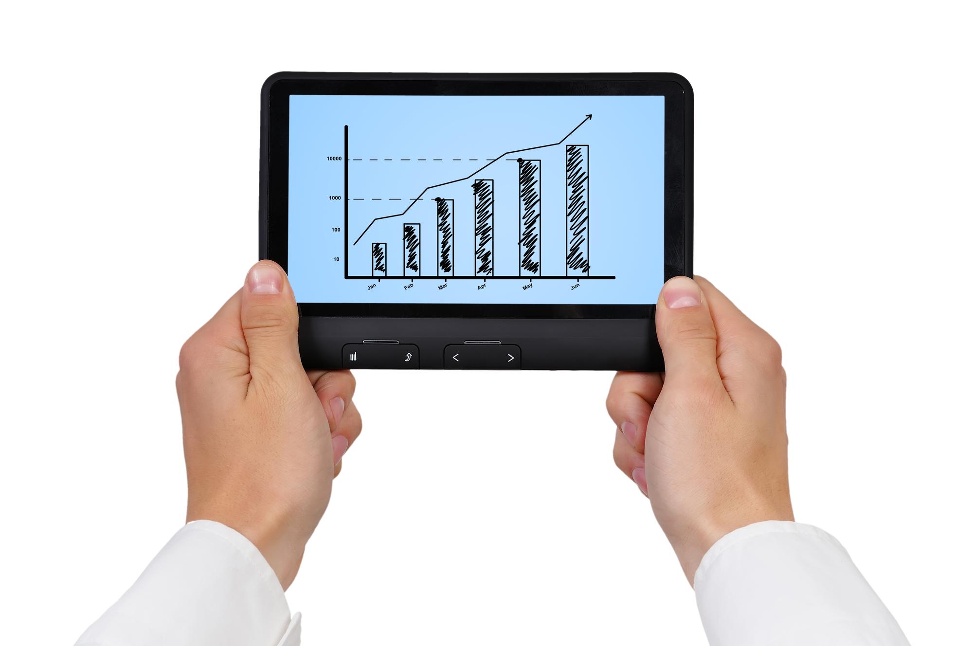 Close-up of hands holding device with chart